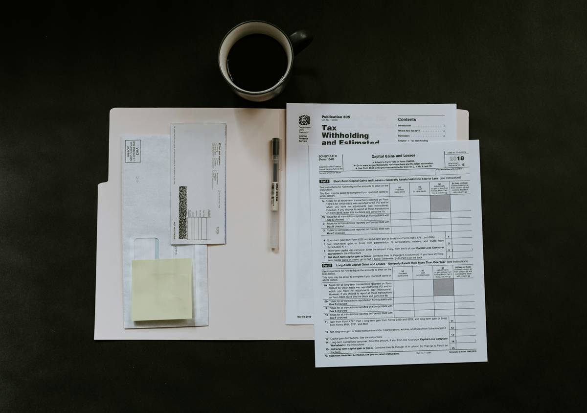 Motorcyclist reviewing Rental Insurance Renewal documents at a cafe before hitting the road