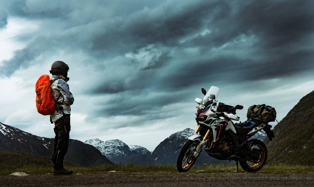 Motorcycle accident scene with helmet and first aid kit beside road featuring Medical Expense Coverage documentation